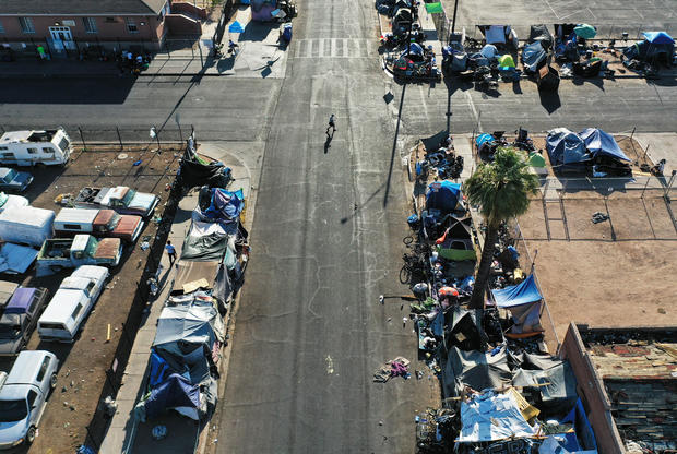 In an aerial view, people walk through Phoenix's largest homeless encampment during the city's worst heat wave on record on July 26, 2023. 