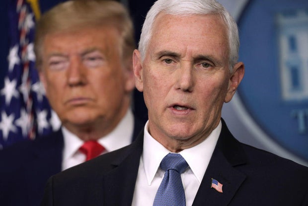 President Donald Trump listens as Vice President Mike Pence speaks during a news conference on Feb. 29, 2020, at the White House.