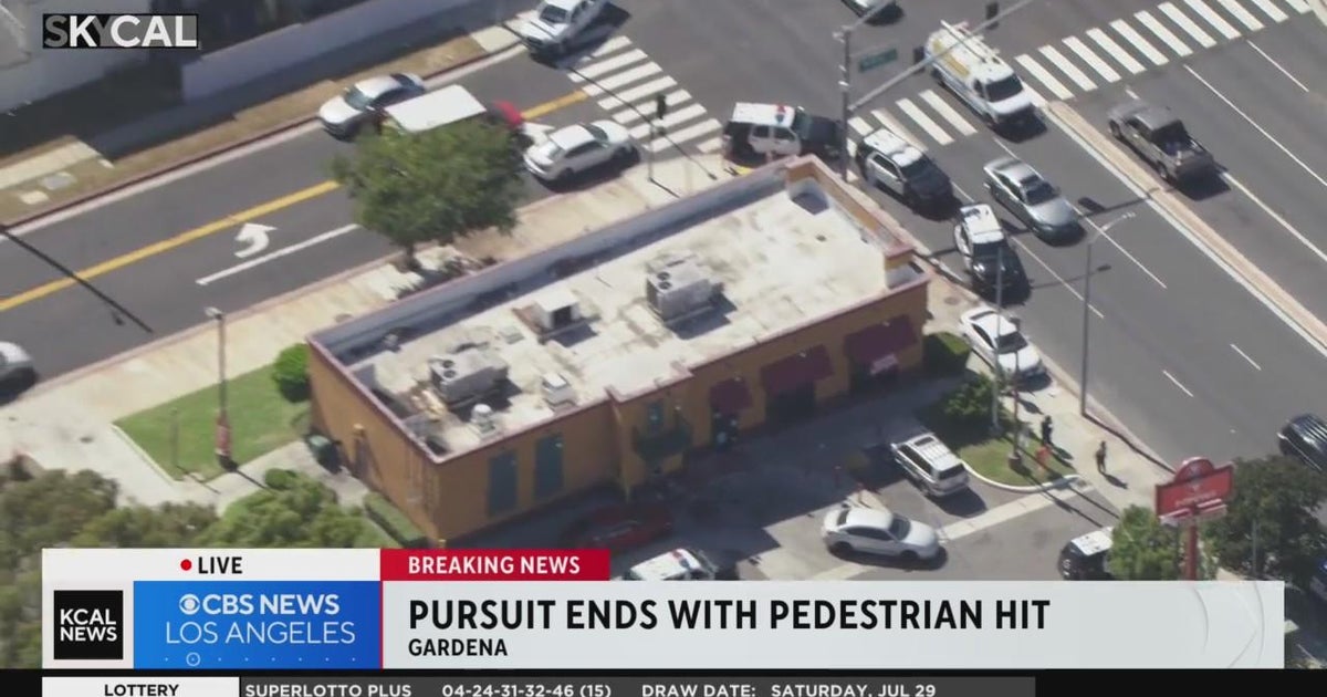 Stolen vehicle pursuit ends as suspect crashes into pedestrian in ...