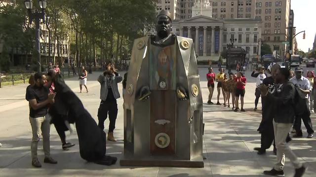 A sculpture of Biggie Smalls wearing a crown is unveiled in Downtown Brooklyn. 