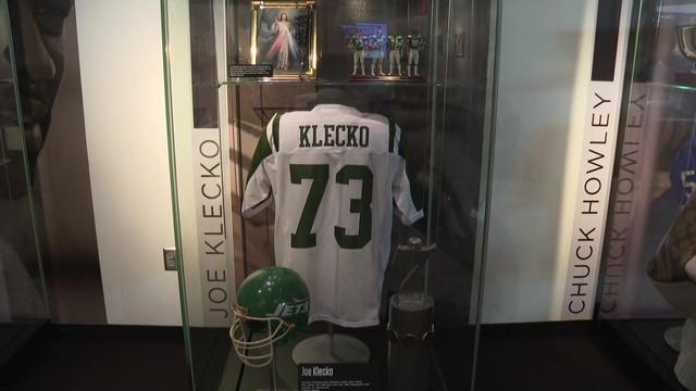 Memorabilia of Joe Klecko's -- including a jersey and a helmet -- inside a plexiglass display inside the Pro Football Hall of Fame. 