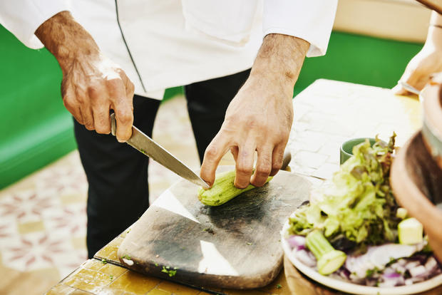 Close up shot of chef cutting zucchini during Moroccan cooking class 