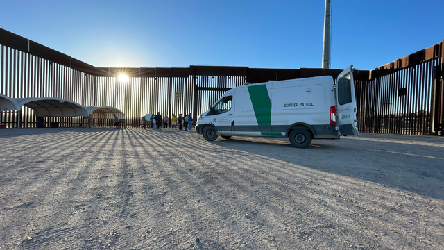 Migrant families and adults are processed by Border Patrol agents near San Luis, Arizona, after receiving water and food from local volunteers. 