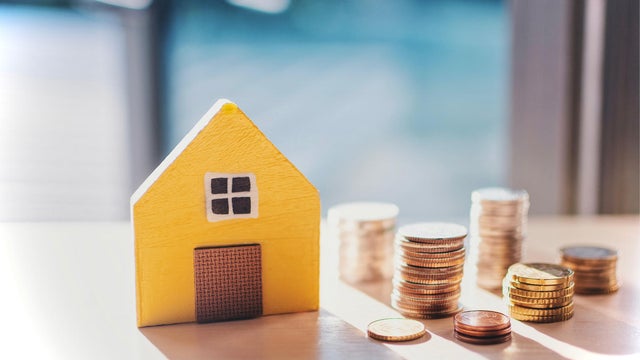 Moving house, relocation. The key was inserted into the door of the new house, inside the room was a cardboard box containing personal belongings and furniture. move in the apartment or condominium 