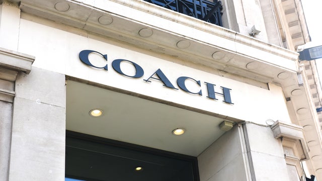 Coach store sign on building exterior 