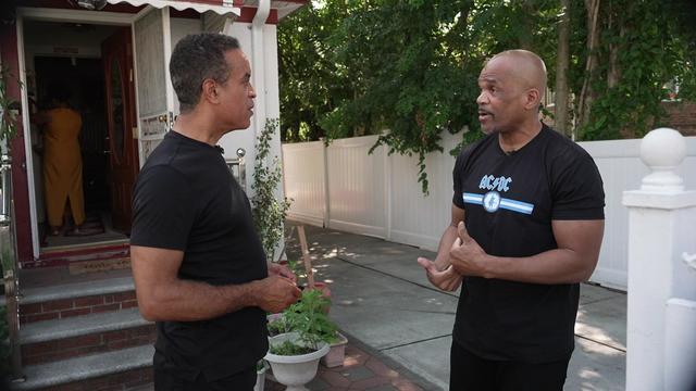 CBS New York's Maurice DuBois and Run-DMC's Darryl McDaniels stand outside McDaniels' old house in Hollis, Queens. 