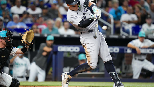 Aaron Judge #99 of the New York Yankees hits a home run against the Miami Marlins during the third inning at loanDepot park on August 11, 2023 in Miami, Florida. 