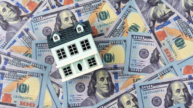 House Model on Top Of Bunch of Money 