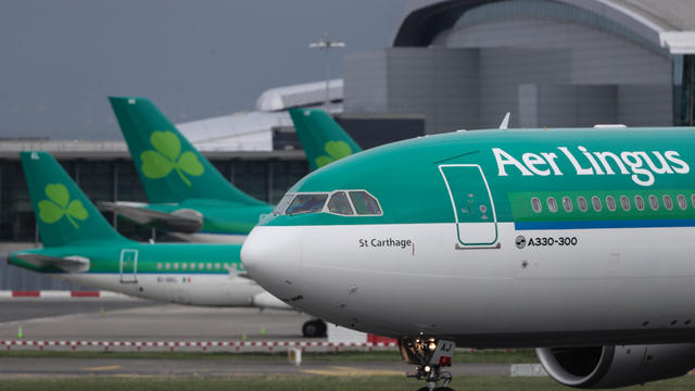 Security and airport officials leave the Aer Lingus plane following a threat against the aircraft at Shannon International Airport, Limerick Ireland 