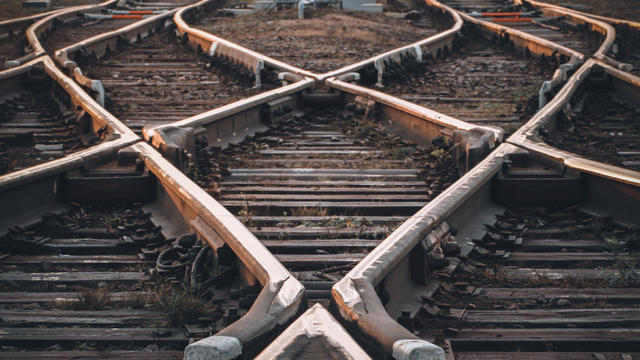 Crossing railway tracks. The concept of the beginning of the way, planning, uncertainty of choices and decisions 