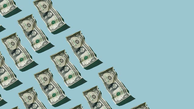 Crumpled one dollar bills on blue background 