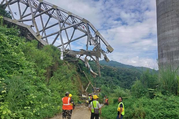Rescue workers conduct a search operation at the site of an accident where an under-construction railway bridge collapsed in Sairang town of the Aizwal district in India's eastern state of Mizoram on August 23, 2023. 