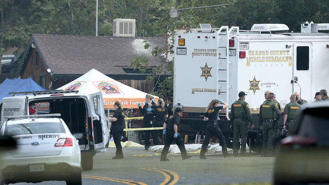 Investigators work the scene where a gunman killed three people and six were taken to hospitals after a shooting Wednesday night at Cook's Corner 