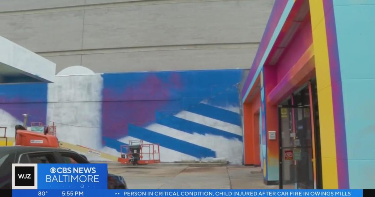 Artist brightens community with mural on auto repair shop ahead of