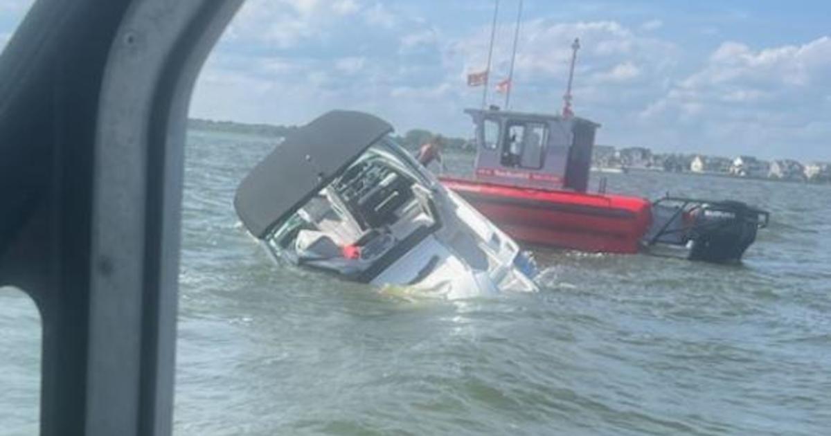 Boat capsizes "moments after" Coast Guard rescues 4 people and dog in New Jersey