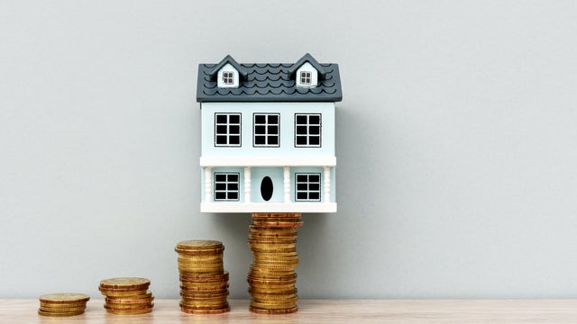 House Model on Top of Stack of Coins 
