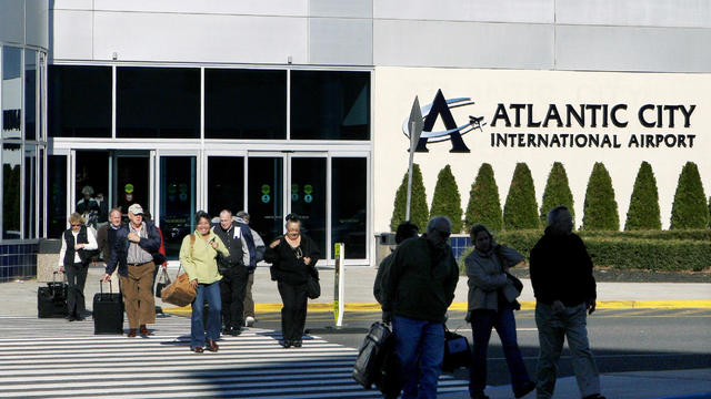 People walk to a shuttle bus after arriving at Atlantic City International Airport in Egg Harbor Township, N.J. 