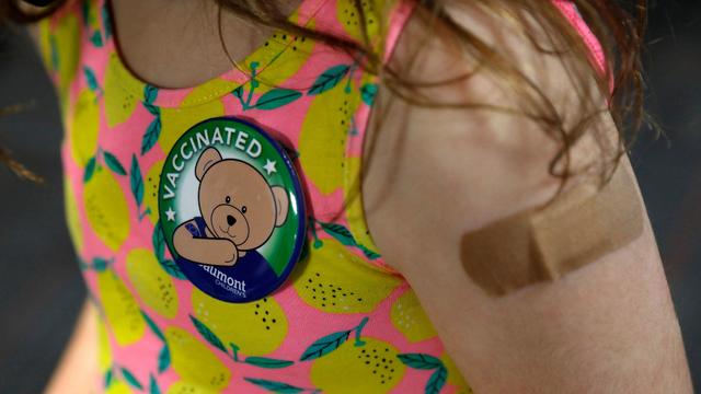 A child wears a pin she received after receiving her first dose of the Pfizer Covid-19 vaccine at the Beaumont Health offices in Southfield, Michigan on November 5, 2021. 