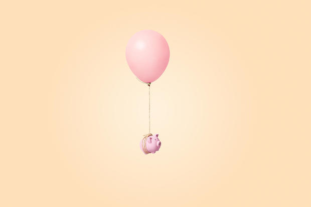 pink piggy bank tied to a balloon 