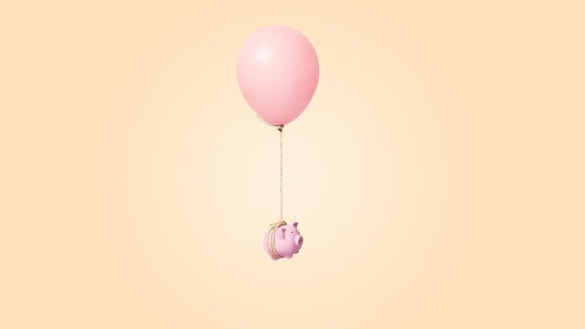 pink piggy bank tied to a balloon 
