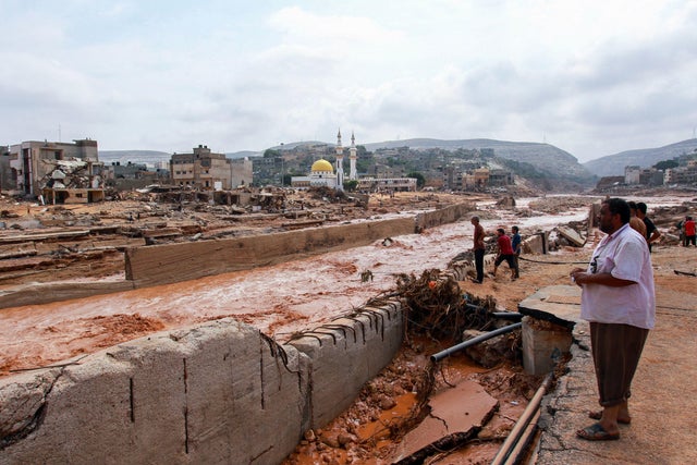 People look at the damage caused by freak floods in Derna, eastern Libya, on September 11, 2023. 