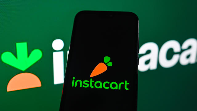 In this photo illustration, the Instacart logo seen 