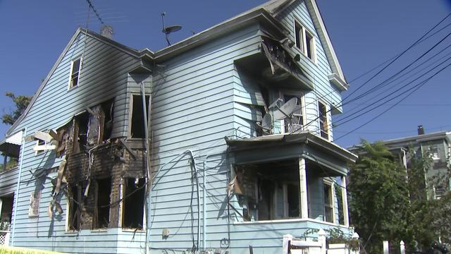 A house with severe fire damage to its exterior. 