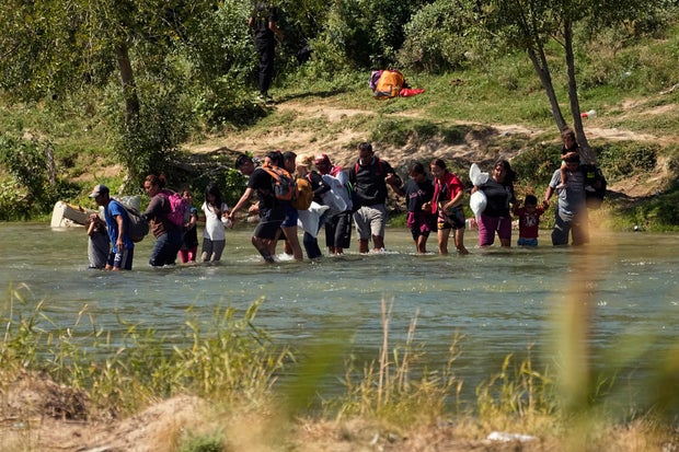 Migrants cross the Rio Grande from Mexico into the U.S. on Thursday, Sept. 21, 2023, in Eagle Pass, Texas.