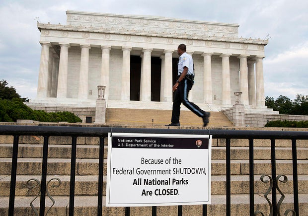 A Park Police officer walks passes a sign announcing the closure of the Lincoln Memorial due to a partial government shutdown in Washington, D.C., on Tuesday, Oct. 1, 2013.