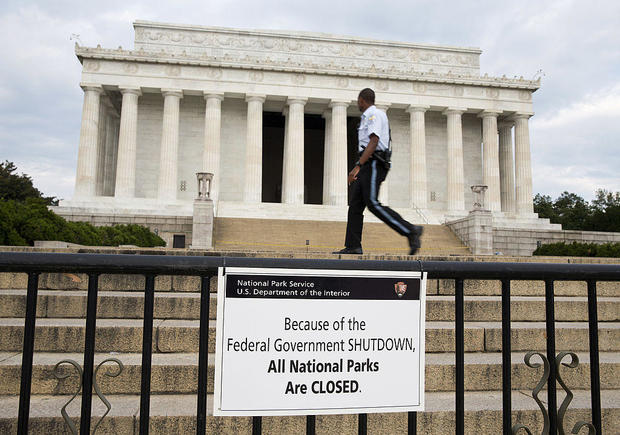 A Park Police officer walks passes a sign announcing the closure of the Lincoln Memorial due to a partial government shutdown in Washington, D.C., on Tuesday, Oct. 1, 2013. 