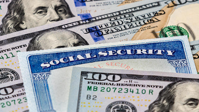 Social Security benefits identification card with 100 dollar bills 