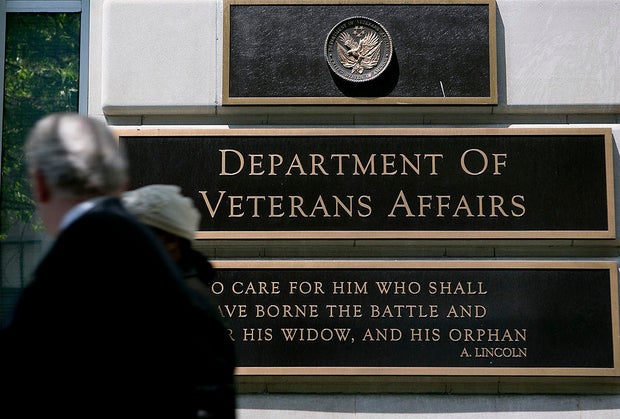 Pedestrians walk past the U.S. Department of Veterans Affairs headquarters in Washington, D.C., on Friday, May 10, 2013.