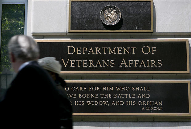 Pedestrians walk past the U.S. Department of Veterans Affairs headquarters in Washington, D.C., on Friday, May 10, 2013. 