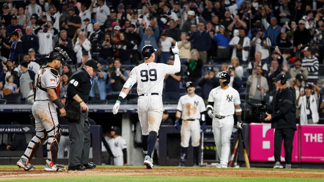 New York Yankees right fielder Aaron Judge (99) gestures at home plate after hitting a solo home run in the seventh inning during a regular season game between the Arizona Diamondbacks and New York Yankees on September 22, 2023 at Yankee Stadium in the Br