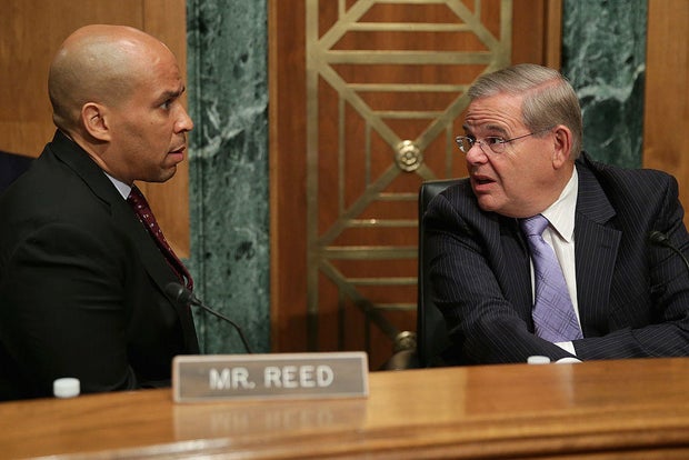 Sen. Cory Booker talks with Sen. Bob Menendez before a hearing at the Dirksen Senate Office Building on Capitol Hill on July 30, 2014.