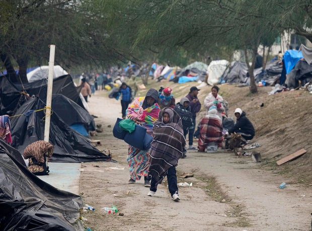Migrants from Venezuela prepare for relocation to a refugee shelter in Matamoros, Mexico, Friday, Dec. 23, 2022.