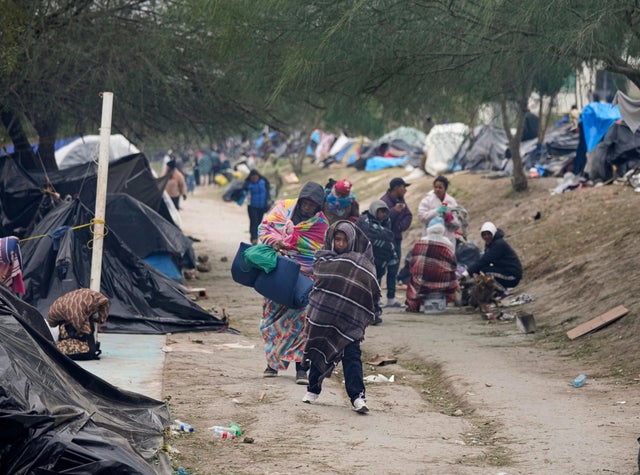 Migrants from Venezuela prepare for relocation to a refugee shelter in Matamoros, Mexico, Friday, Dec. 23, 2022.