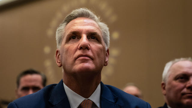 Speaker of the House Kevin McCarthy is surrounded by press and police on the way to the House chamber at the Capitol in Washington on Tuesday, Oct. 3, 2023. 