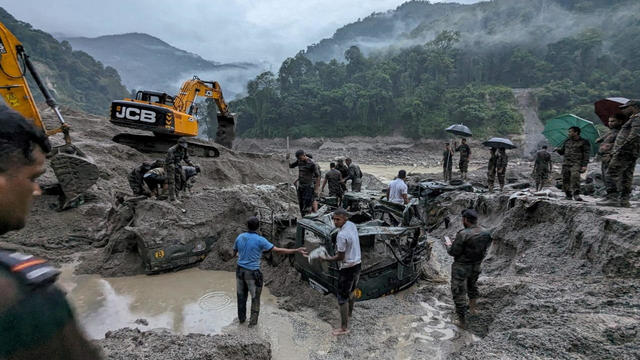 Members of Indian Army try to recover trucks buried at the area affected by flood in Sikkim 