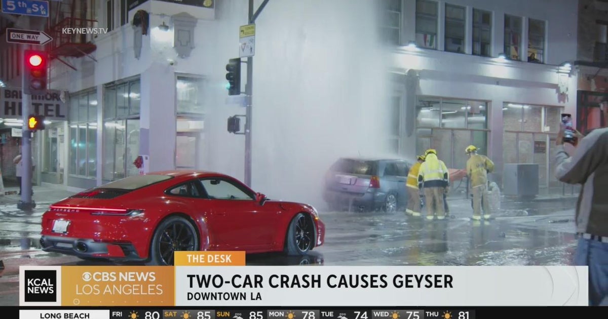 A geyser shoots water downtown LA after a car crashes into a fire