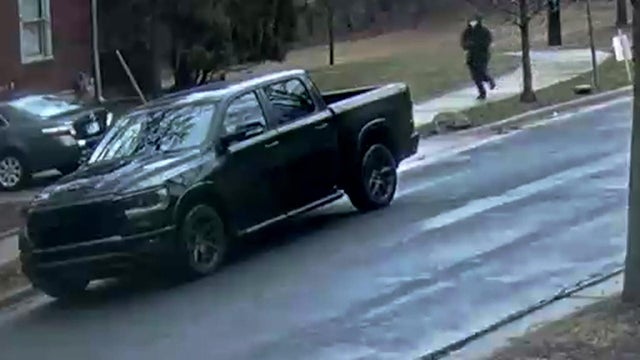 lThe shooter running back to the black truck 