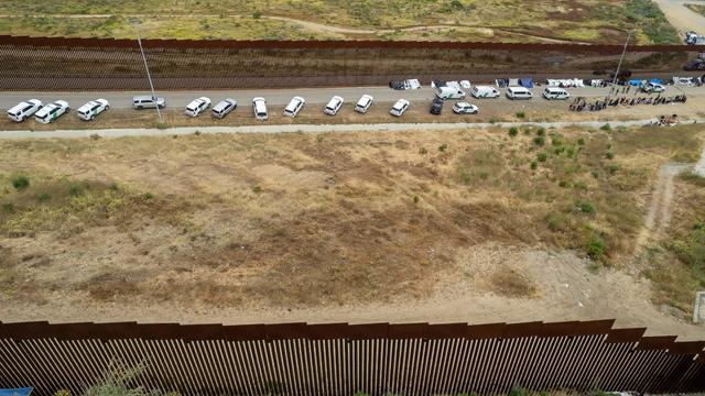 Aerial view of migrants waiting to be processed between border wall fences on the United States side of the U.S.-Mexico border, seen from Tijuana, Baja California state, Mexico, on May 11, 2023. 