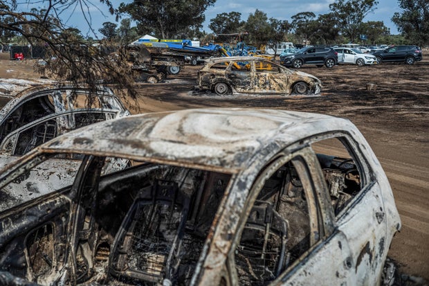 Destroyed vehicles are seen near the grounds of a music festival after a deadly attack by Hamas militants, near Re'im, Israel, Oct. 10, 2023.