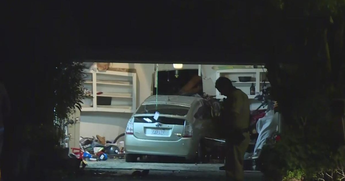 Driver suspected of DUI drives crashes car into garage