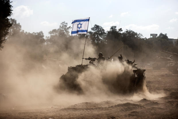 An Israeli Armoured Personnel Carrier (APC) takes position near Israel's border with the Gaza Strip 