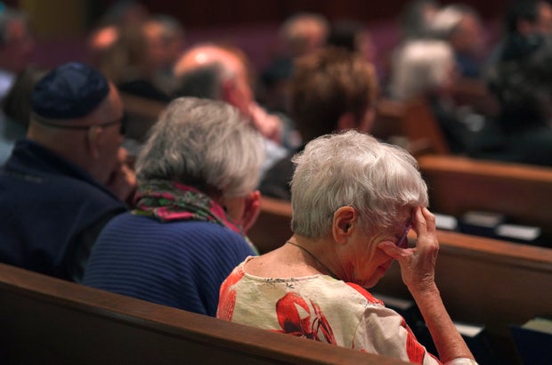 Worshippers are seen sitting in silent prayer while at a Shabbat service at Temple Sinai in Pittsburgh on Oct. 13, 2023. Photo by Jessie Wardarski / AP