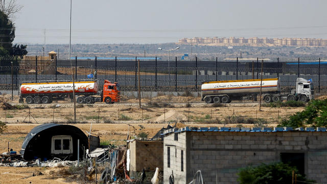 UN-flagged fuel trucks move towards border crossing in Gaza 