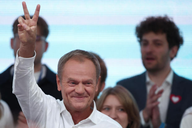 Donald Tusk, leader of the opposition group Civic Coalition, gestures after exit poll results are announced in Warsaw, Poland, Oct. 15, 2023. 
