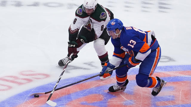 Arizona Coyotes Center Nick Schmaltz (8) and New York Islanders Center Mathew Barzal (13) battle for the puck during the first period of the National Hockey League game between the Arizona Coyotes and the New York Islanders on October 17, 2023, at UBS Are 