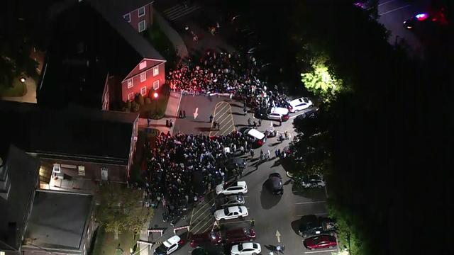 An aerial view of a large crowd of demonstrators, some pro-Israeli and some pro-Palestinian, outside Teaneck City Hall. 